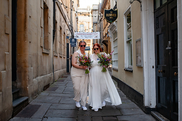 newlywed-brides-walking-st-nicks-market-bristol
