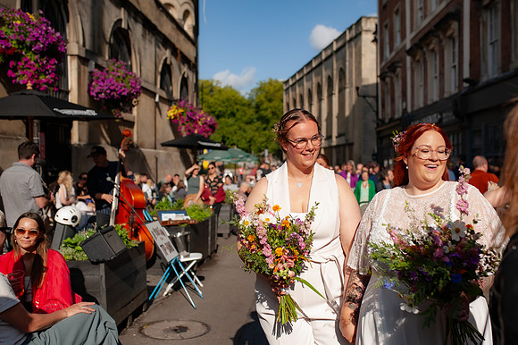 newlywed-brides-walking-st-nicks-market-bristol-3
